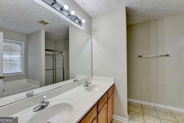 bathroom featuring a textured ceiling, separate shower and tub, and vanity