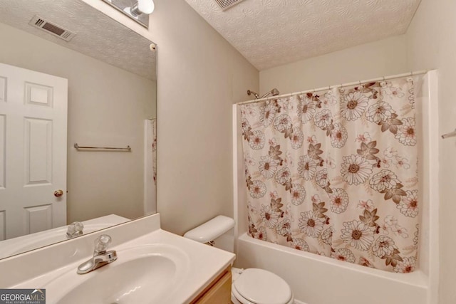 full bathroom with a textured ceiling, shower / tub combo, vanity, and toilet