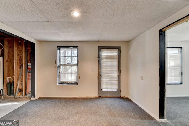 empty room with a paneled ceiling and carpet