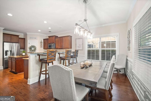 dining space featuring ornamental molding, a notable chandelier, and dark wood-type flooring