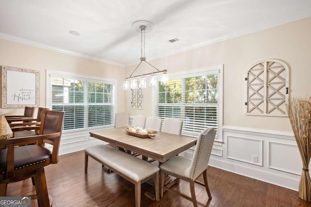 dining room featuring ornamental molding and dark hardwood / wood-style floors