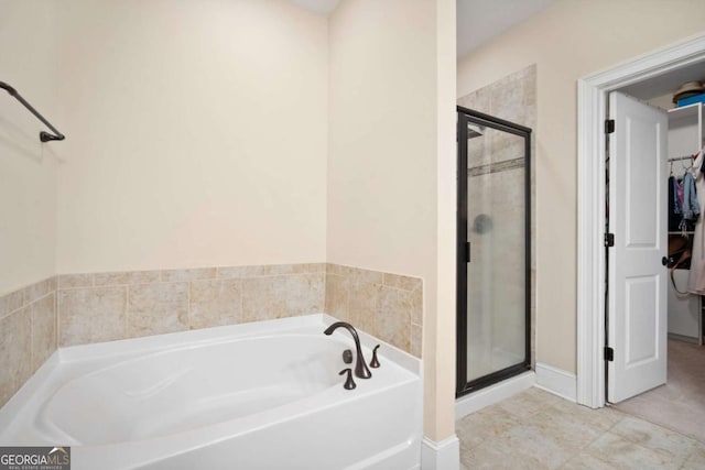 bathroom featuring separate shower and tub