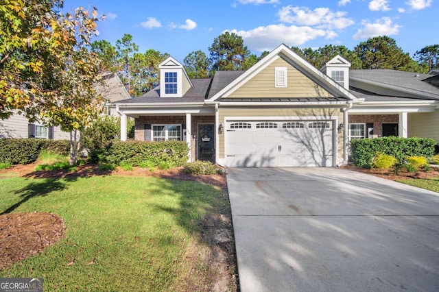 new england style home featuring a front yard and a garage