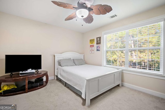 bedroom featuring ceiling fan and light colored carpet