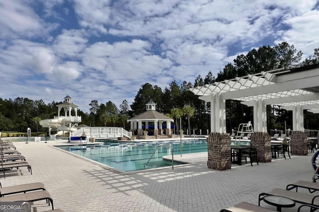 view of swimming pool with a pergola and a patio area