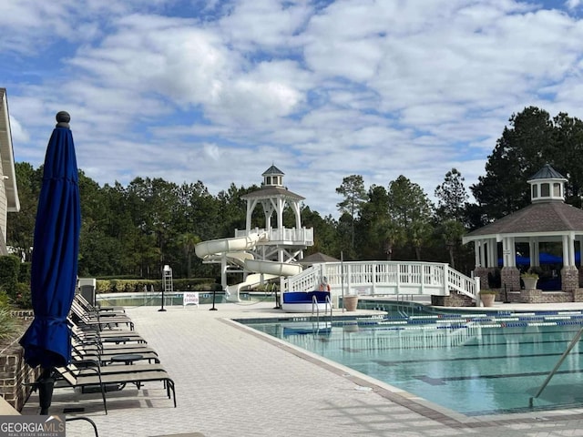 106 Danbury Ct, Pooler, GA 31322 - community pool featuring a water slide, a gazebo, a patio, and view of wooded area
