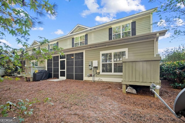 back of house with a sunroom