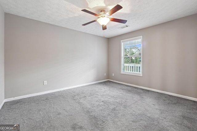 carpeted empty room featuring a textured ceiling and ceiling fan