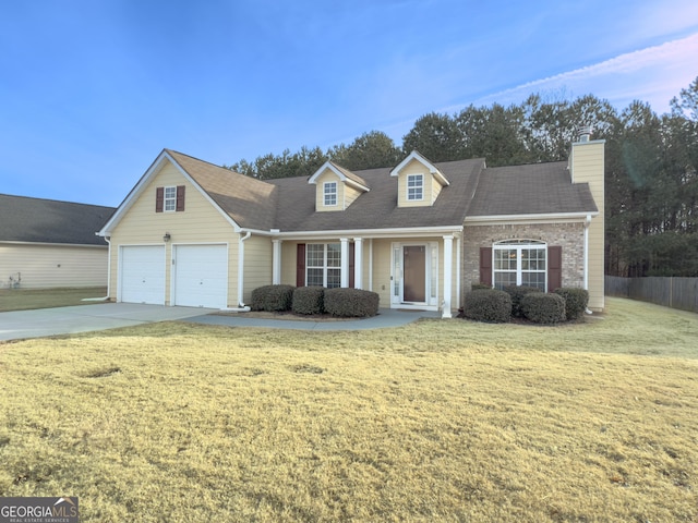 cape cod house featuring a front lawn and a garage