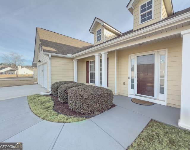 view of exterior entry with a garage