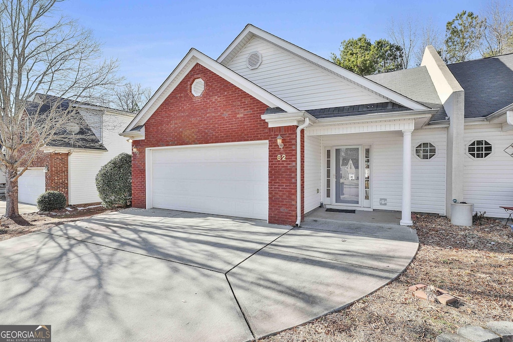 view of front property with covered porch and a garage