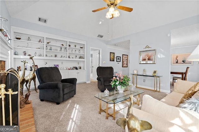 living room featuring lofted ceiling, built in shelves, ceiling fan, and a brick fireplace