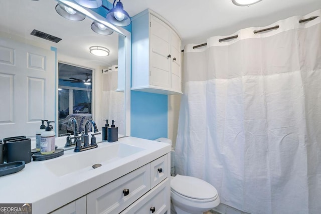 bathroom featuring toilet and vanity