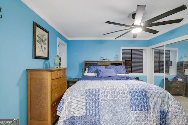 bedroom featuring ceiling fan and crown molding