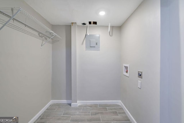 laundry area featuring electric panel, light hardwood / wood-style flooring, hookup for a washing machine, and hookup for an electric dryer