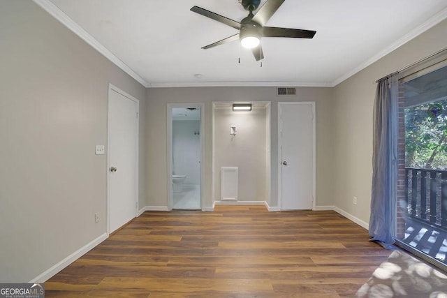 unfurnished bedroom with dark wood-type flooring, ceiling fan, crown molding, and connected bathroom