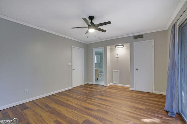 unfurnished bedroom with crown molding, ceiling fan, dark hardwood / wood-style floors, and connected bathroom