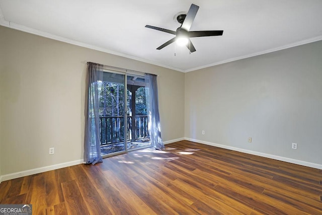 empty room featuring dark wood-type flooring, ceiling fan, and crown molding