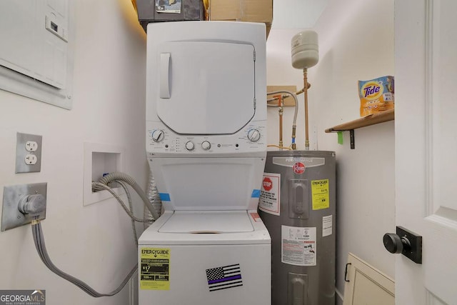 washroom featuring electric panel, water heater, and stacked washer and dryer