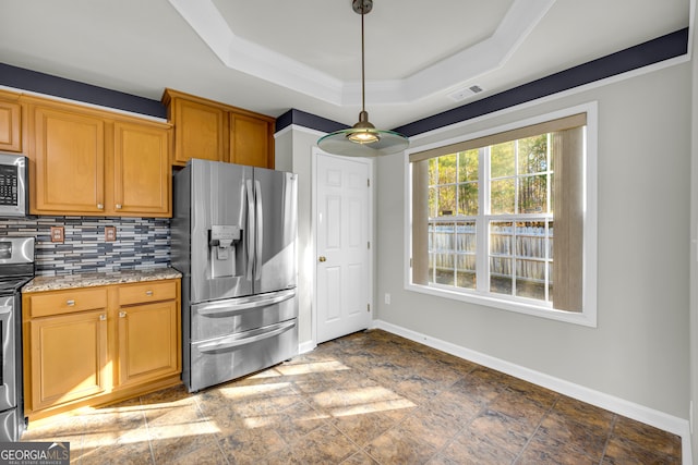 kitchen with stainless steel appliances, pendant lighting, backsplash, light stone countertops, and a tray ceiling