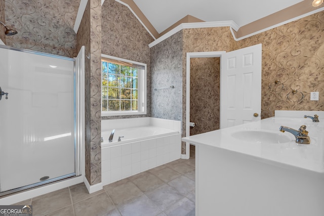 bathroom with lofted ceiling, tile patterned floors, ornamental molding, independent shower and bath, and vanity