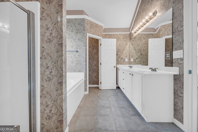 bathroom featuring lofted ceiling, vanity, crown molding, and a tub