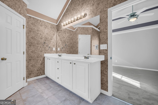 bathroom with lofted ceiling, ceiling fan, tile patterned floors, vanity, and crown molding