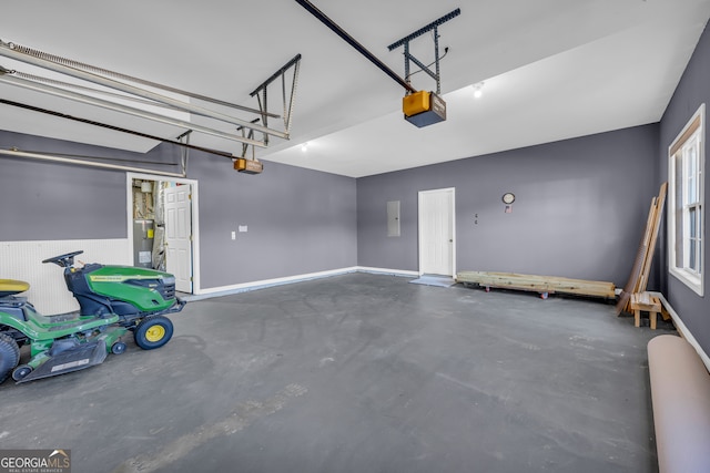 garage featuring a garage door opener and electric water heater