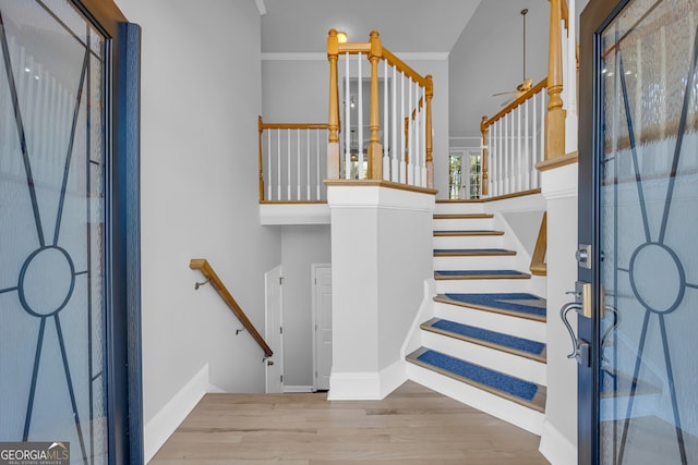 entrance foyer featuring wood-type flooring and ornamental molding