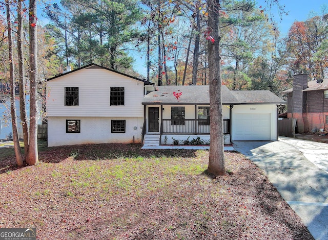 tri-level home featuring a garage and covered porch