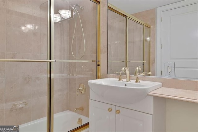 bathroom featuring vanity and combined bath / shower with glass door