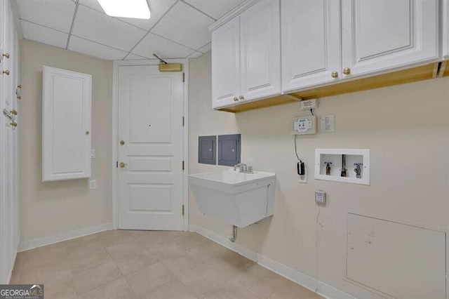 clothes washing area featuring hookup for a washing machine, cabinets, and sink