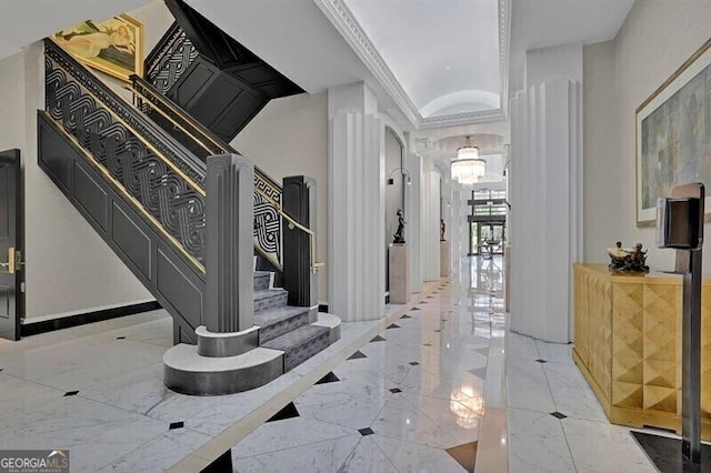 corridor with an inviting chandelier and lofted ceiling