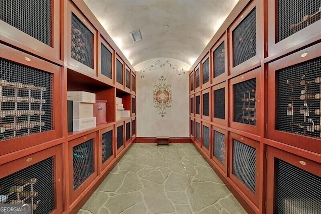 wine area featuring brick ceiling and lofted ceiling