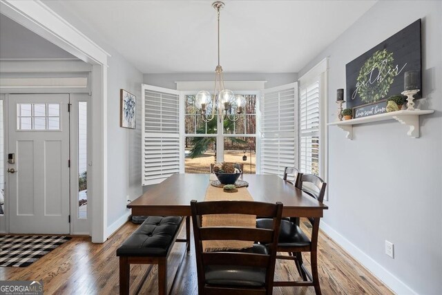 dining space with a chandelier, hardwood / wood-style floors, and a healthy amount of sunlight