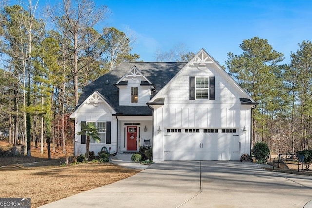 view of front of property with a garage, concrete driveway, board and batten siding, and roof with shingles