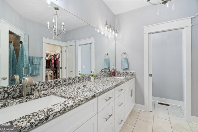 bathroom with ornamental molding, tiled shower, vanity, and tile patterned floors