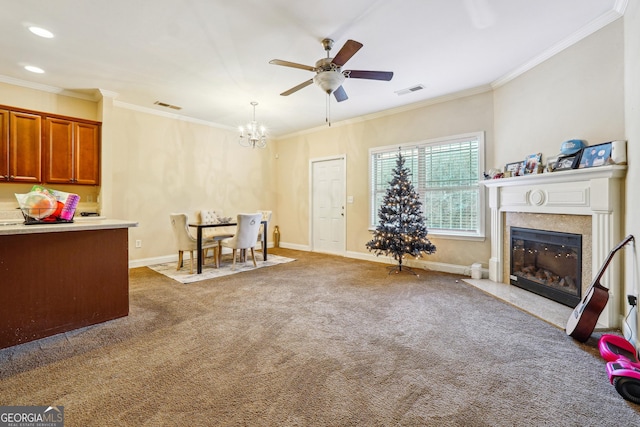 carpeted living room with ceiling fan with notable chandelier and crown molding