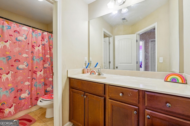 bathroom with toilet, vanity, tile patterned flooring, and walk in shower