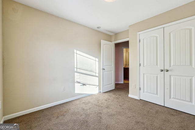 unfurnished bedroom with a closet and carpet