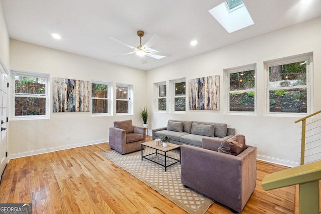 living room with ceiling fan and wood-type flooring