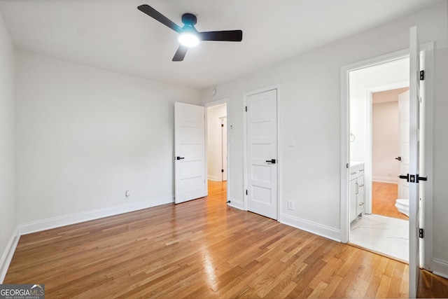 unfurnished bedroom with ensuite bath, ceiling fan, and light hardwood / wood-style flooring