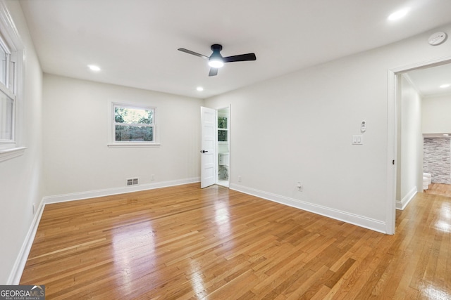 spare room with ceiling fan and light wood-type flooring