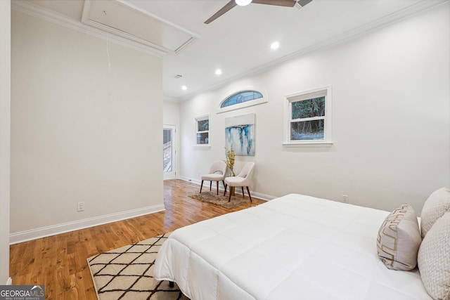 bedroom with ceiling fan, hardwood / wood-style flooring, and crown molding