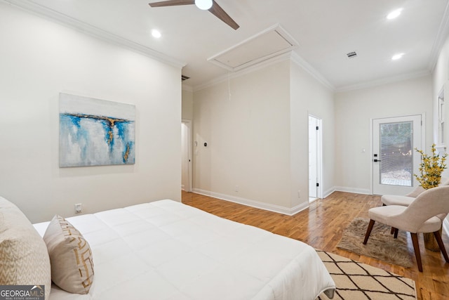 bedroom featuring ceiling fan, crown molding, and hardwood / wood-style flooring