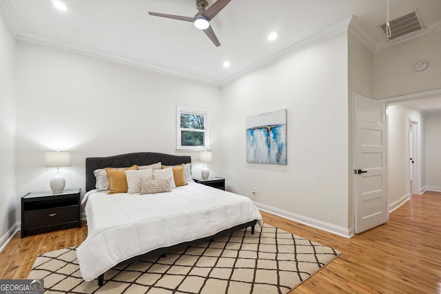 bedroom with ceiling fan, ornamental molding, and hardwood / wood-style floors