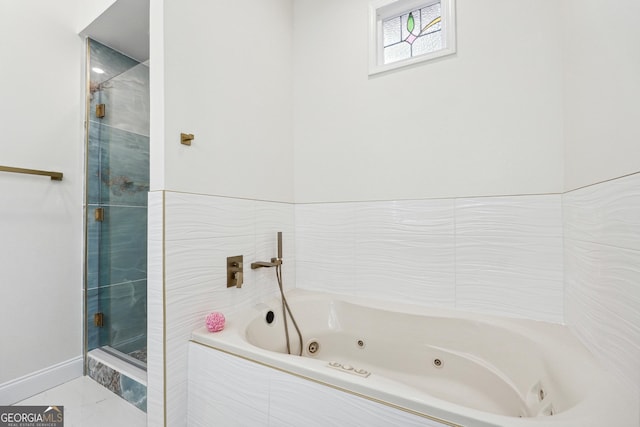 bathroom featuring separate shower and tub