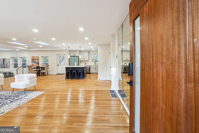 living room featuring plenty of natural light and light hardwood / wood-style flooring