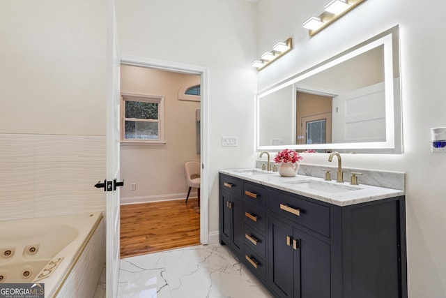 bathroom with vanity and a bath