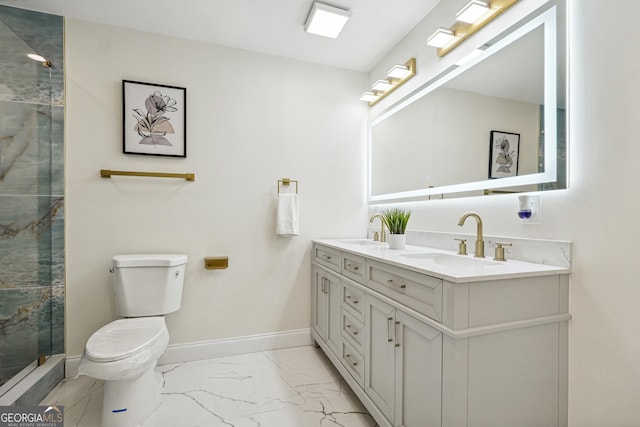 bathroom with toilet, vanity, and a shower with door